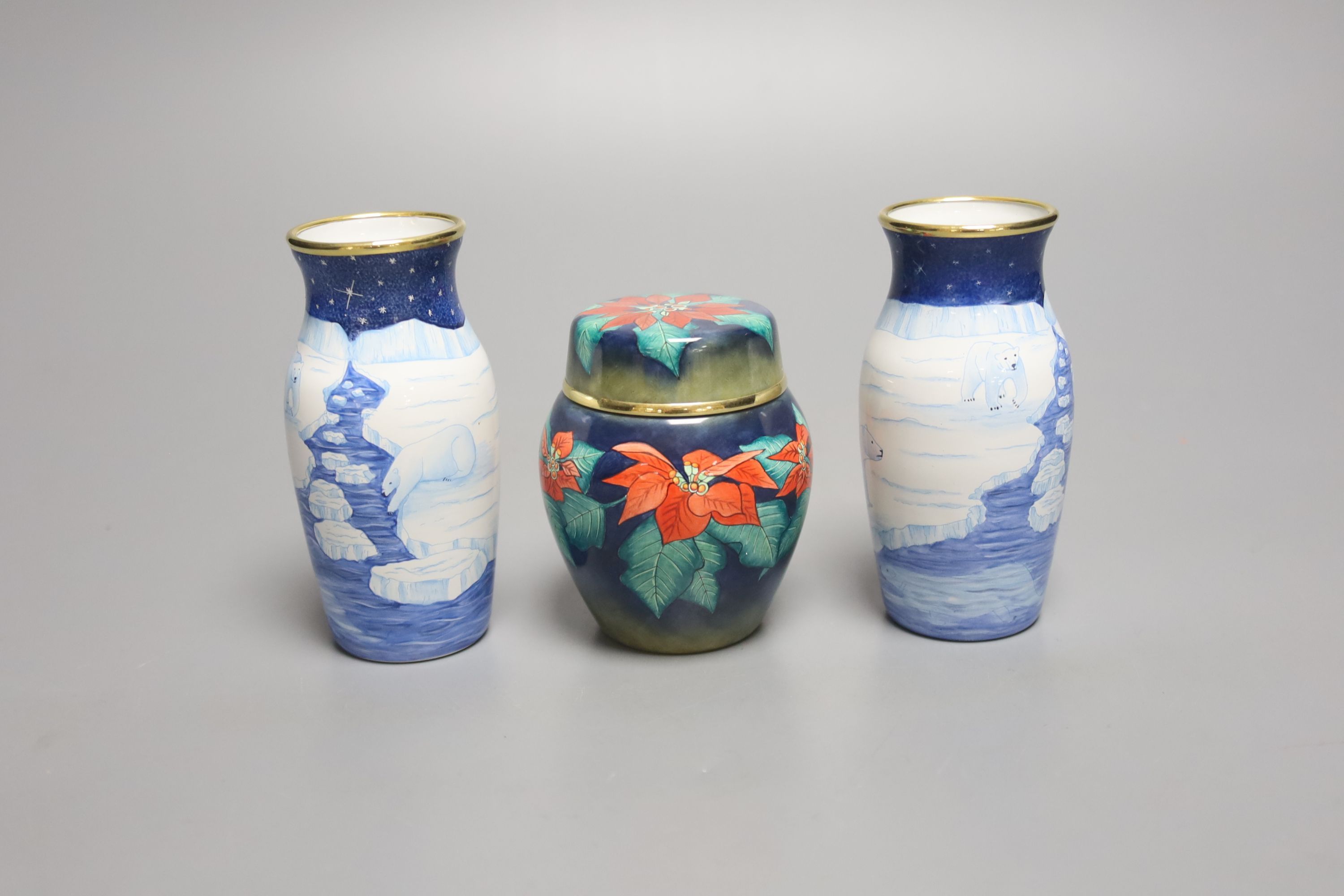 A pair of modern Moorcroft enamel on metal vases, decorated with polar bears, and a similar jar and cover, tallest 9cm